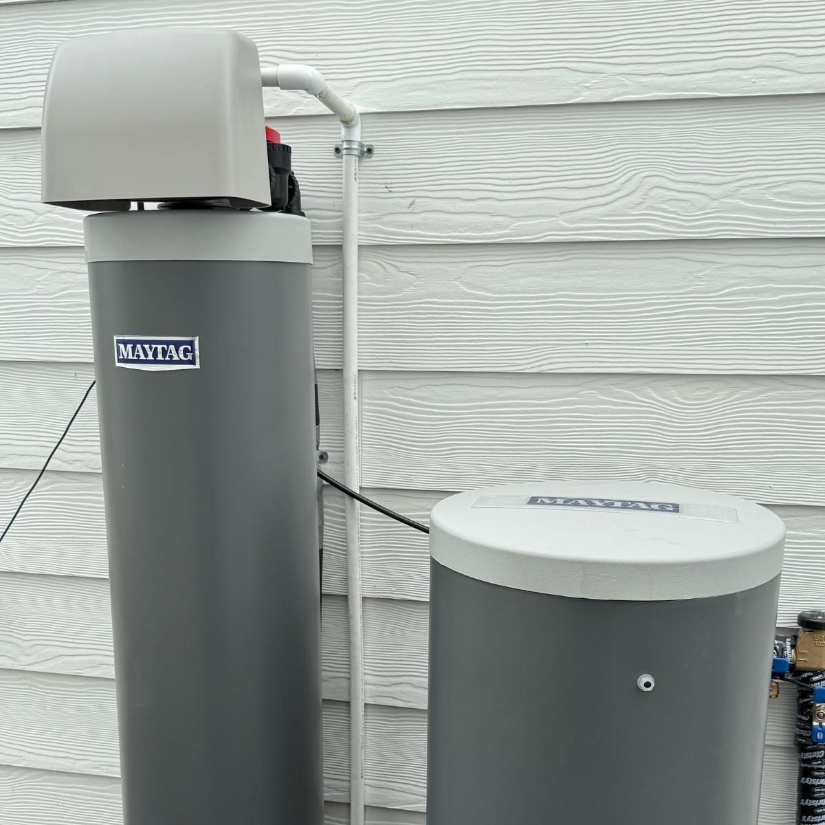 Maytag water treatment system professionally installed outside home