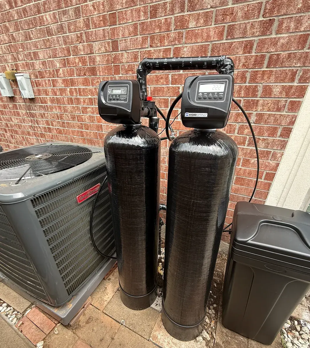 Dual-tank water softener and filtration system installed outdoors