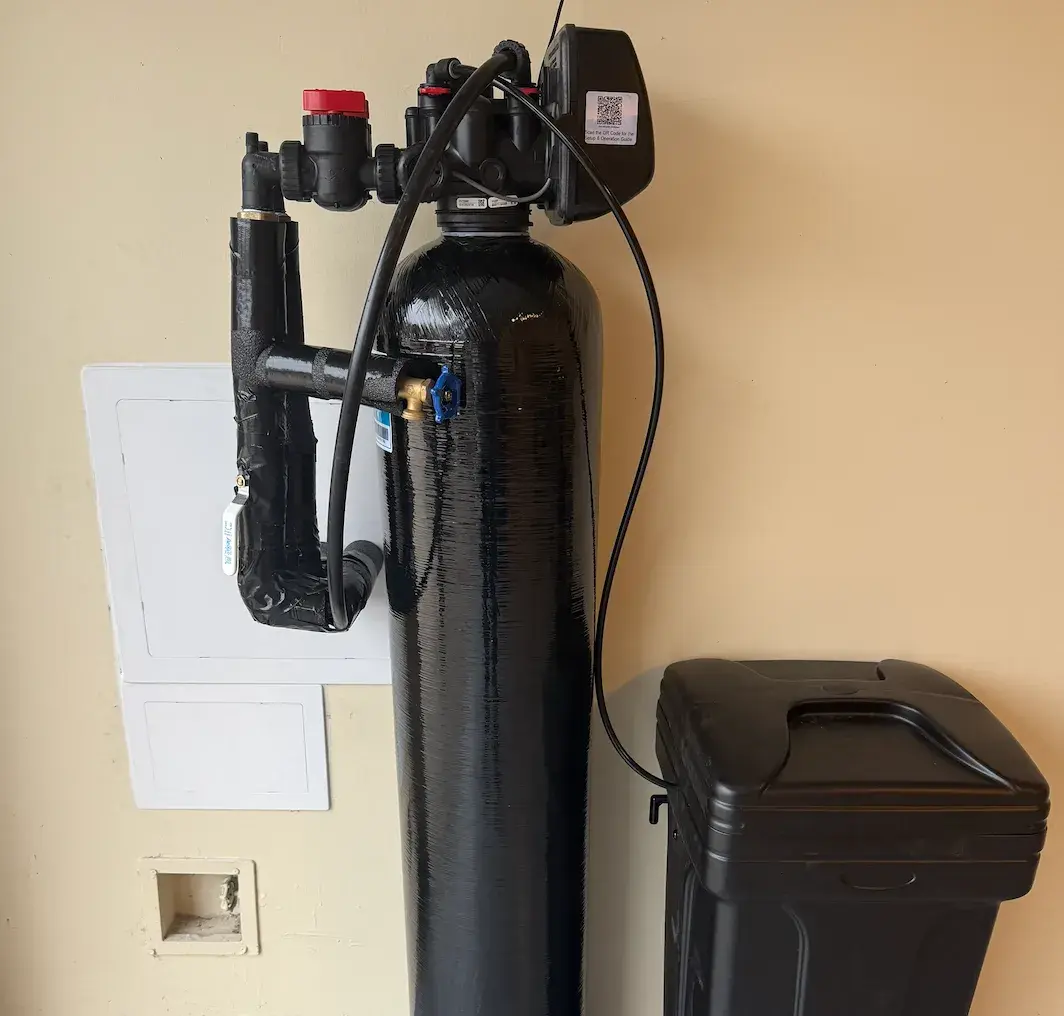 Wall-mounted water softener system with brine tank